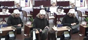 STICKUP — A bank security camera filmed this bewigged thief.  But the disguise didn’t work.