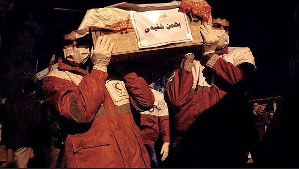 LAST TRIP — Iraqi Red Crescent workers carry the coffins of the 15 murdered Iranians across the border into Iran.