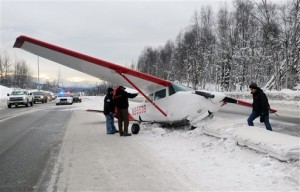 WHAT’S THE NEXT STEP? — A highway crew prepares for a task it doesn’t face every day—removing an aircraft from the middle of a highway.