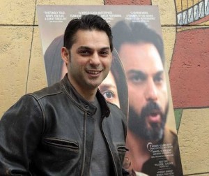 SEEING DOUBLE — Peyman Moadi stands beside a poster showing him in his role in “A Separation.”