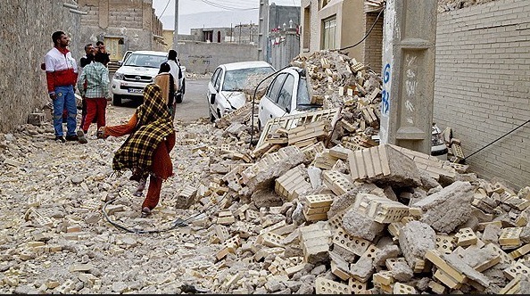 AFTERMATH — Residents of Bastak survey the debris left after a 5.5 earthquake shook the town, destroying 800 homes but killing only one resident. 