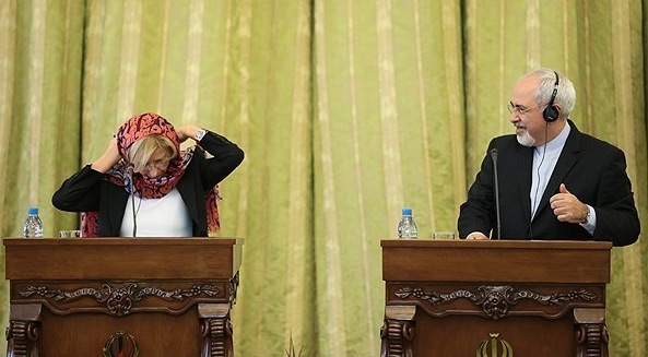 TANGLED — Italian Foreign Minister Emma Bonino struggled with her headscarf as she prepared for a news conference with Iranian Foreign Minister Mohammad-Javad Zarif (right) in Tehran last month.  Bonino was one of the first of what is becoming a flood of visiting foreign politicians.