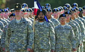 RARITY — Simranpreet Lamba (in turban) is the only enlisted man in the US Army who has permission to wear a beard and turban.  The 26-year-old Indian-born Sikh won an exemption because he has a skill the Army badly needs—mastery of both the Hindi and Punjabi languages.  But now others may make it into the US armed forces as the rules are loosened a bit.
