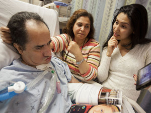 MEDICAL — Hassan Rasouli has been comatose for 3 1/2 years.  His wife, Parichehr Salasel (center), and daughter, Mojgan, believe he still responds to them when they show him family photos, as they are doing here.