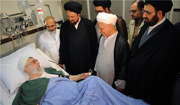 VISITORS — Everybody who is anybody has paid a visit to the Supreme Leader in his hospital bed.  This early group included former President Ali-Akbar Hashemi-Rafsanjani (in gray tunic) and Hassan Khomeini, Ayatollah Khomeini’s grandson, to Rafsanjani’s right.