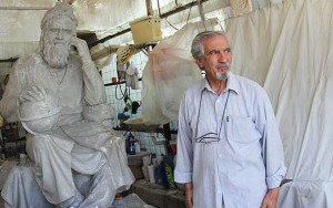 CARVED IN STONE — Sculptor Hossain Fakhimi stands beside the statue of Omar Khayyam he has recently completed to be installed in Manhattan.