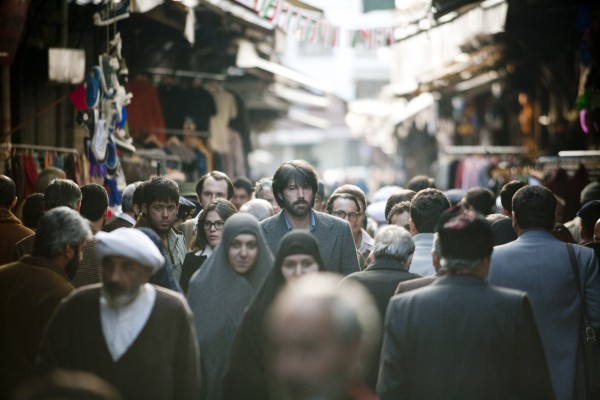 MYTHOLOGY — In one of the dramatic scenes from the film “Argo,” actor Ben Affleck (tall bearded man at center) led the six Americans hiding from revolutionaries through the Tehran Bazaar above.  In reality, it never happened.