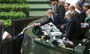 REACHING — Since long before the revolution, this has been the traditional photo at budget time, showing the head of the government handing his budget to the Majlis speaker. 