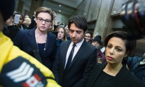 EYES LOWERED — Jian Ghomeshi (left) leaves court in Toronto with his defense attorney, Marie Henein.