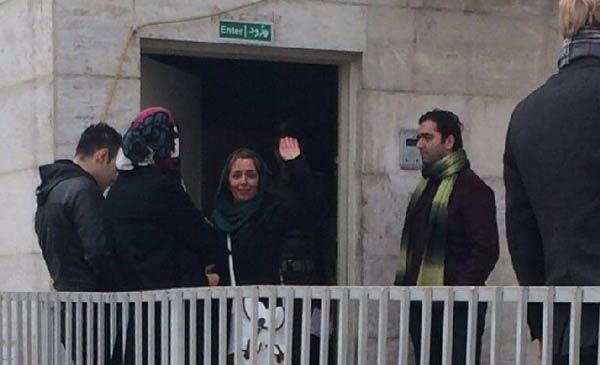 BEHIND THE WALLS — Reyhaneh Tabatabaie waves to supporters just before she went behind the door of Evin Prison to begin a one-year sentence.