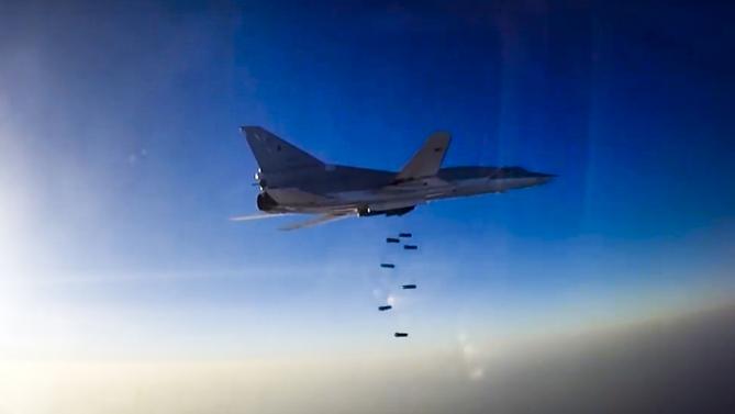 BOMBS AWAY — This photo from the Russian Defense Ministry shows a Tu-22 bomber based at Hamadan as it dropped bombs on a target in Syria.