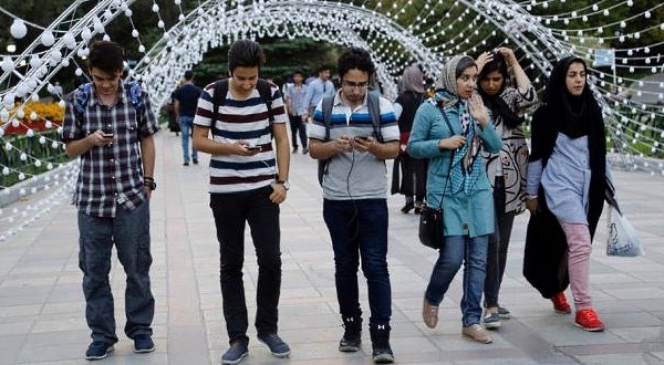 EVERYBODY WANTS TO PLAY — Students in North Tehran’s Mellat Park were entranced last week by Pokemon Go.