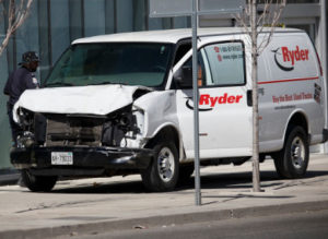 AFTERMATH — Police inspect the rental van used as a weapon to mow down pedestrians along a main artery leading into Toronto, Ontario.