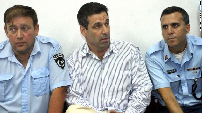 AWAITING TRIAL — Former Israeli Energy Minister Gonen Segev (center) sits between two Israeli policemen as he is arraigned in court on charges of spying for Iran.