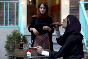 SANCTIONED — Are US sanctions working?  They aren’t stopping this young woman from enjoying a Coke along with her Marlboro cigarette.