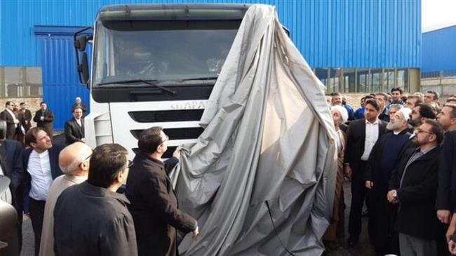 RE-INAUGURAL — President Rohani (in turban at right) helps to re-open a truck plant that was abandoned by Germany’s Mercedes Benz.