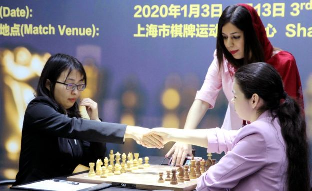 TOO FAR BACK — Shohreh Bayat can be seen refereeing this match with a head covering, but it is so far back on her head that it is only barely visible.