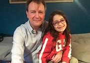 WAITING — Richard Ratcliffe and his daughter, Gabriella, wait by the Christmas tree in their London home for Gabriella’s mother to return.