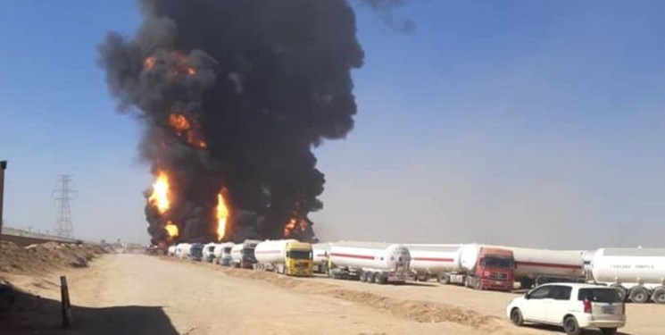 BLAST — Flames shoot into the sky as the huge mass of parked tanker trucks trying to get into Afghanistan begins to burn.  