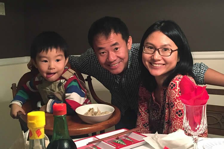 XIYUE WANG. . . with wife and son after release