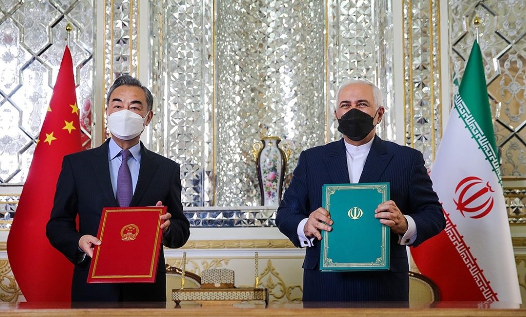 TOGETHERNESS — Chinese Foreign Minister Wang Yi (left) and Iranian Foreign Minister Mohammad-Javad Zarif show off their copies of the new strategic agreement they had just signed.