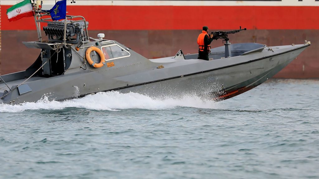 WARFARE — This Pasdar photo shows Iranian speedboats swirling about near a US destroyer and a Vietnamese tanker.