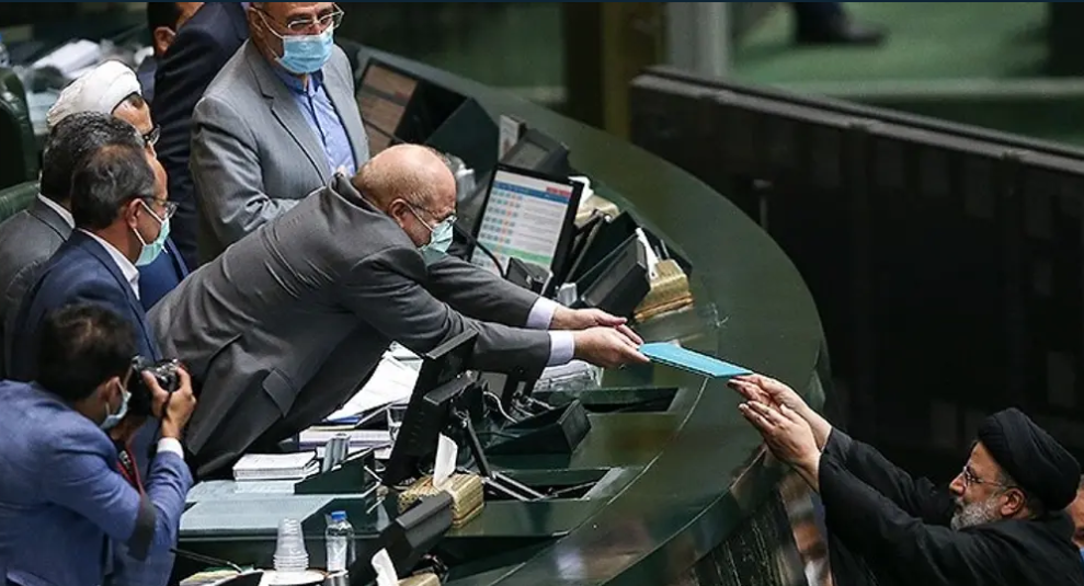 TRADITION — In a photo taken for almost a century, the chief of government hands his draft budget over to the speaker of the Majlis.