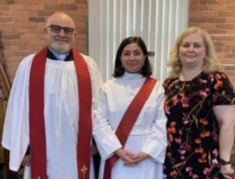 ORDAINED — Melina Dezhbod stands between her parents at her odination ceremony.