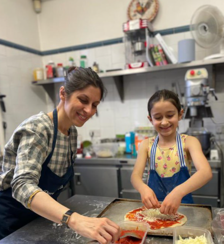 PIZZA — Nazanin Zaghari Ratcliffe and her soon to be eight-year-old daughter Gabriella do some fun work together preparing a pizza meal for the family.