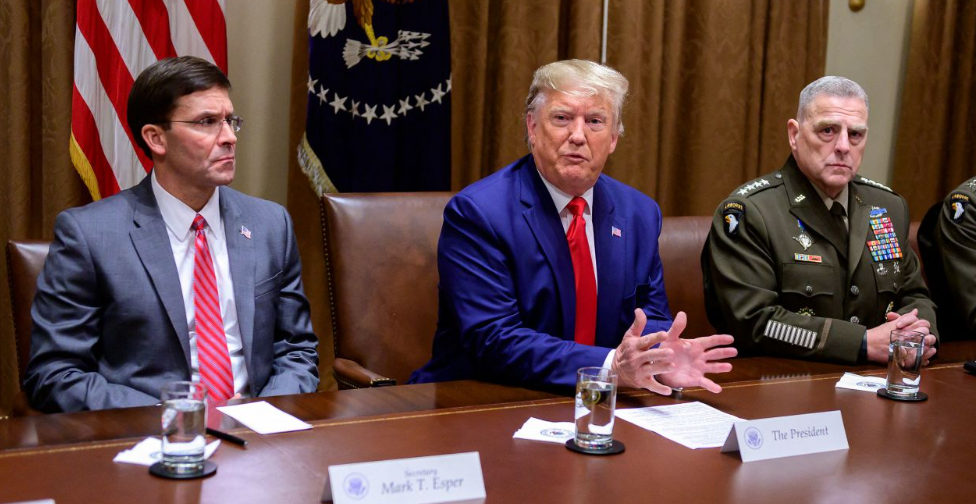 TRIO — Secretary of Defense Mark Esper and Gen. Mark Milley, the chairman of the Joint Chiefs of Staff, bookend President Donald Trump at a White House meeting in 2020.